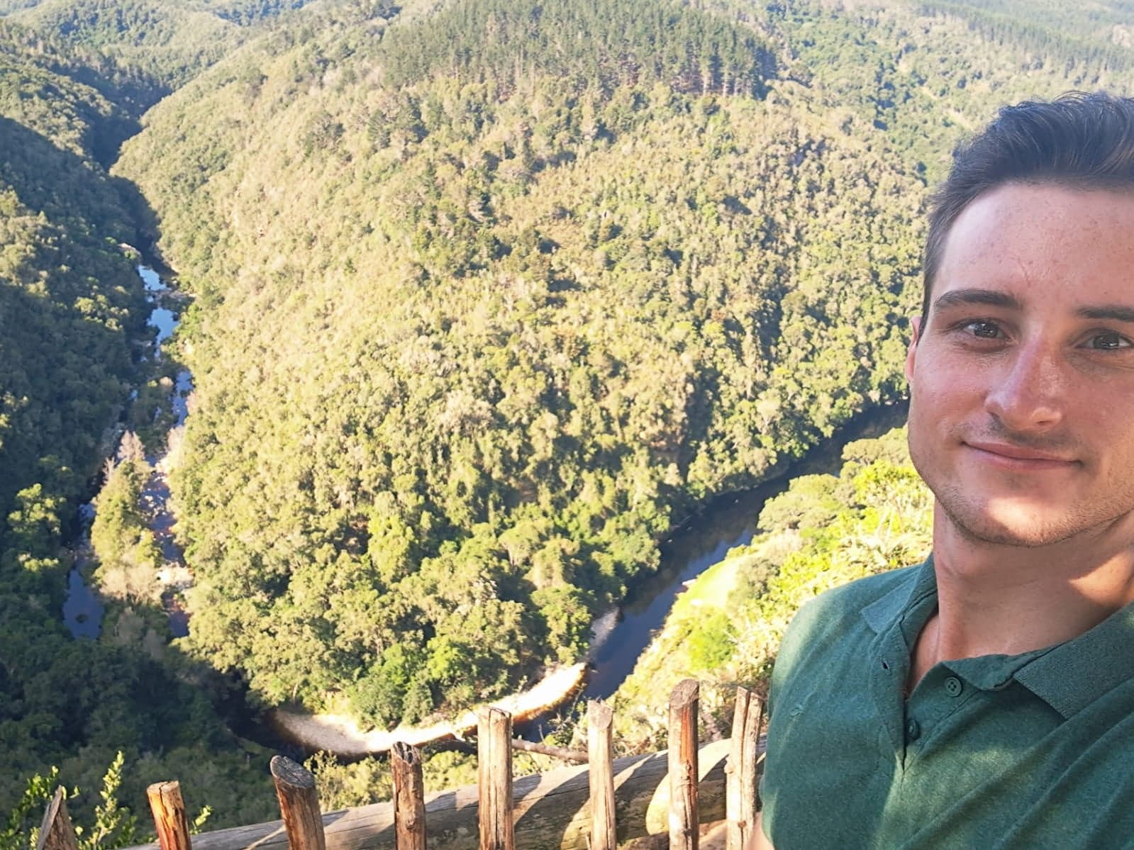 Arno Christie at a lookout above a forested river valley